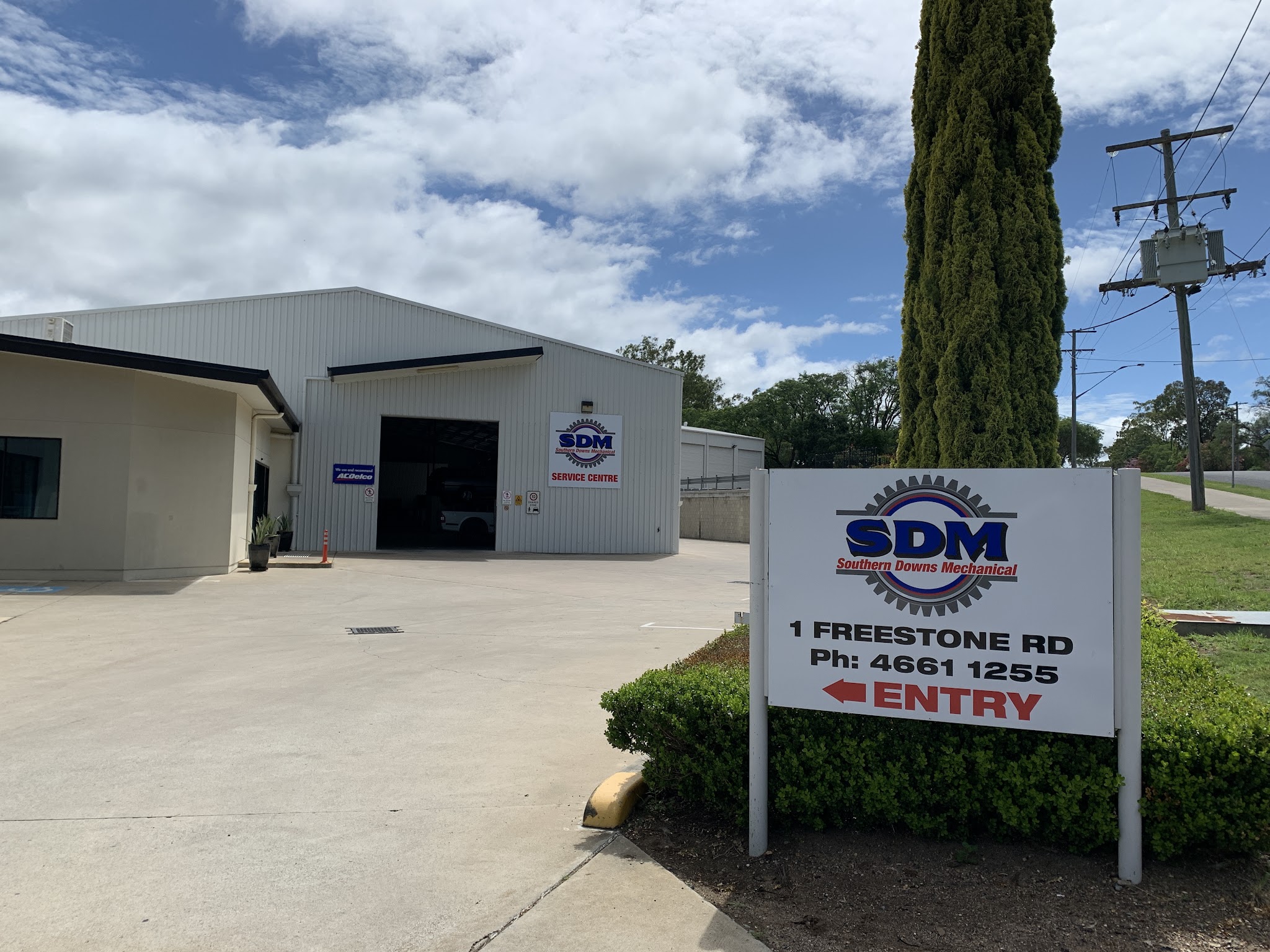 The Southern Downs Mechanical workshop at 1 Freestone Road, Warwick, with the SDM Service Centre sign and the roadside entry sign