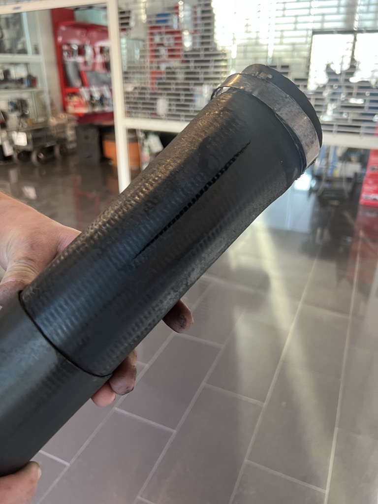 A split turbo induction hose held up in the Southern Downs Mechanical workshop reception